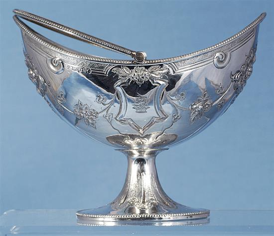 A Victorian silver swing handled sugar basket and sifter spoon, by Martin, Hall & Co, basket height 190mm, weight 7.7oz/241grms.